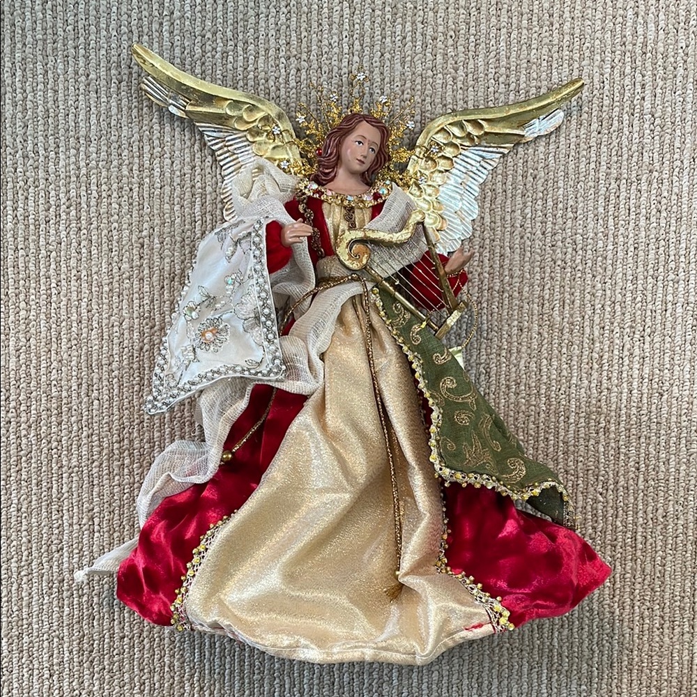 Mark Roberts tree topper angel playing harp.